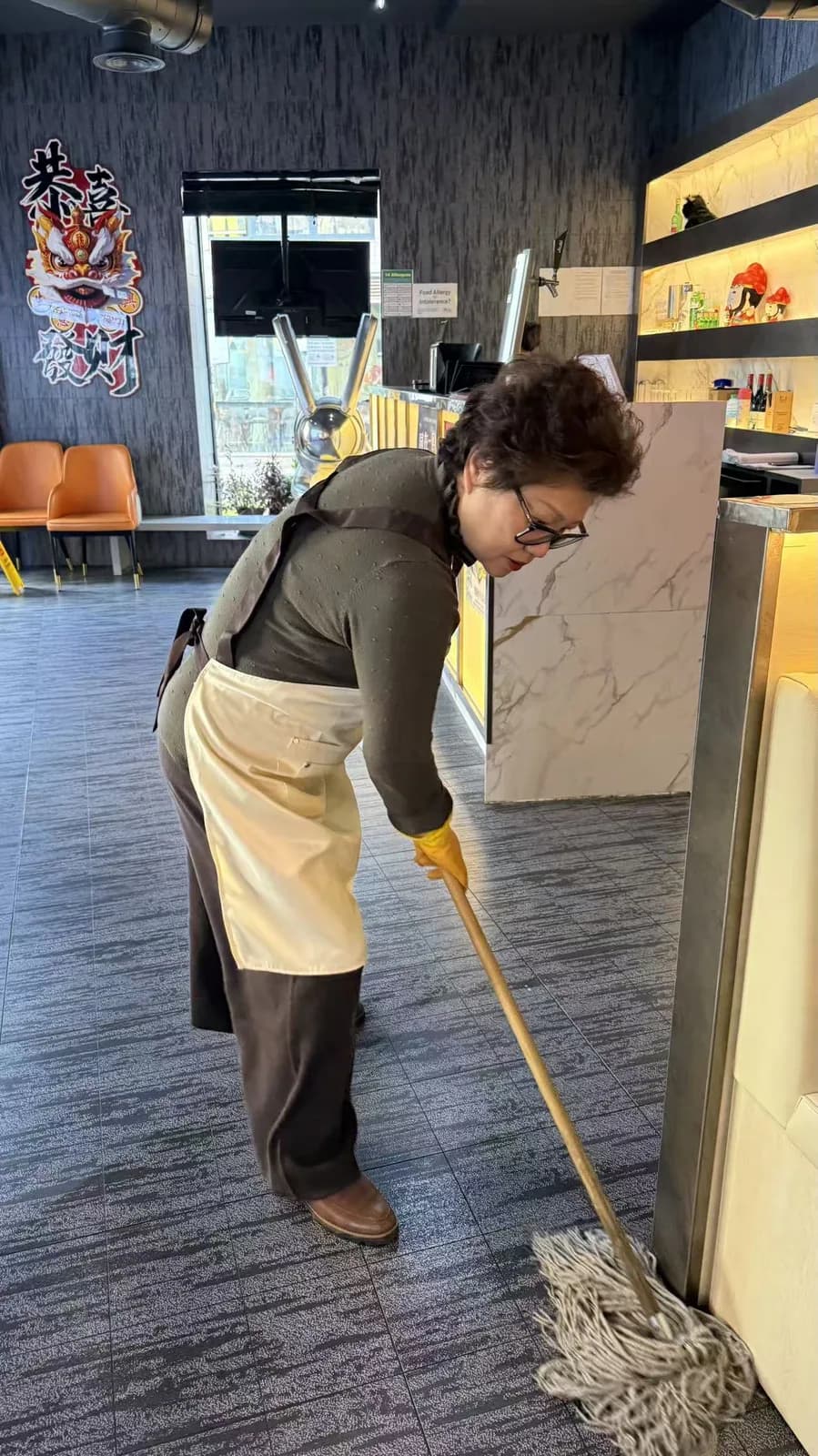 Ping Jie cleaning by the bar