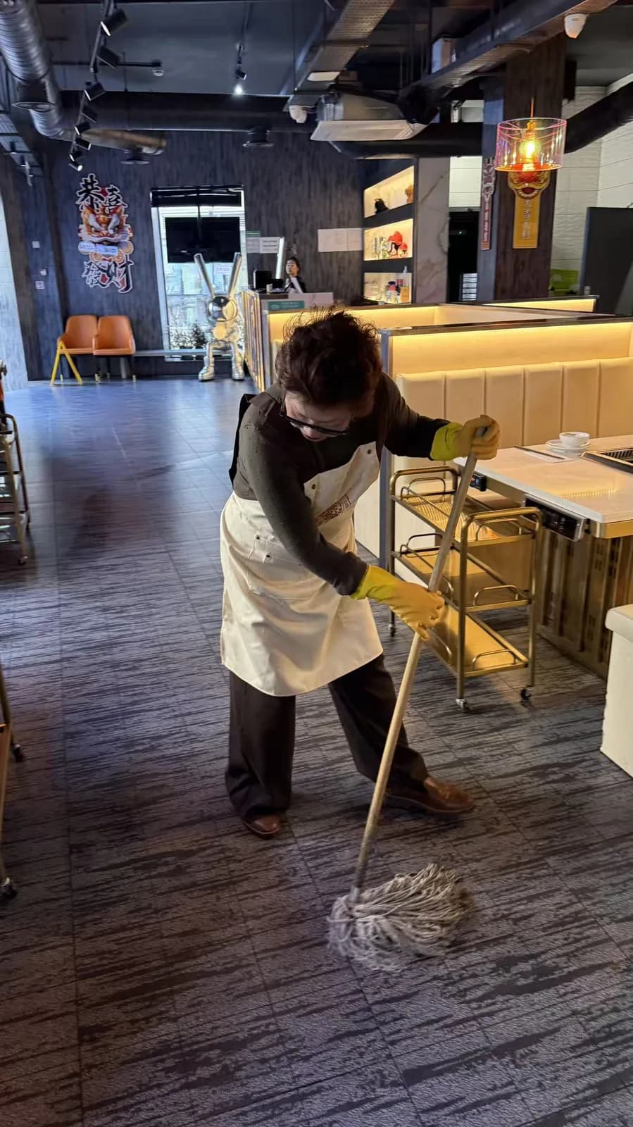 Ping Jie cleaning the dining area